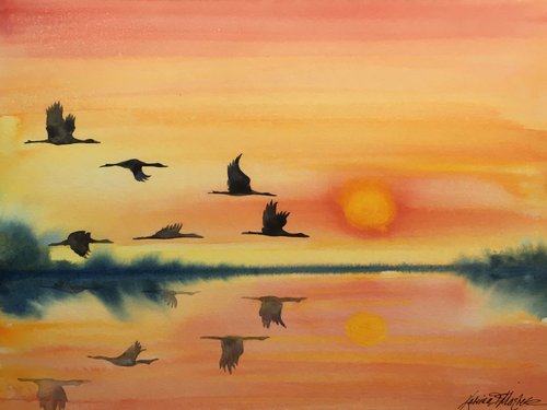 watercolor of warm sunset colors with flying cranes reflected on water
