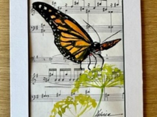 watercolor painting of butterfly and plant on sheet music